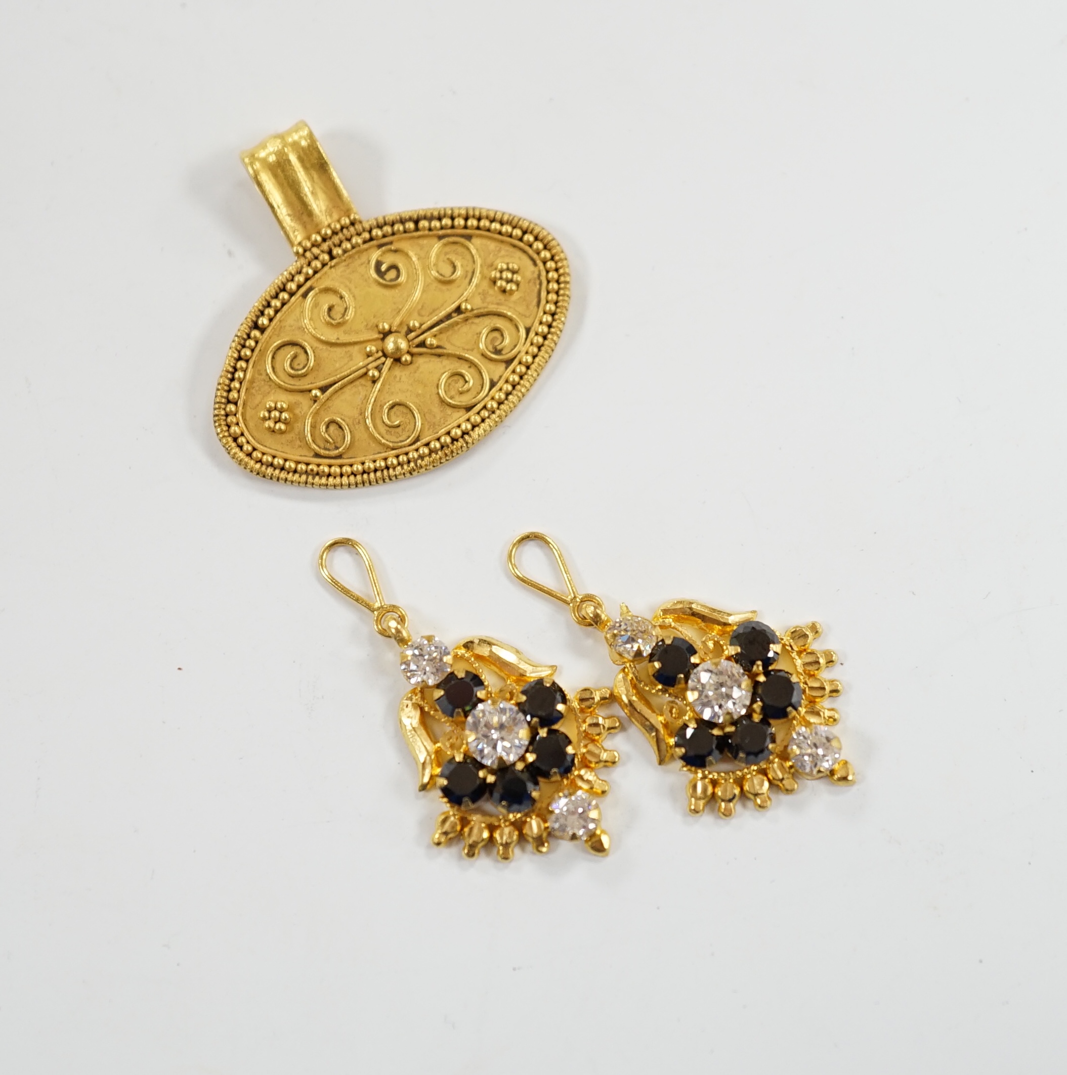 A pair of Middle Eastern two colour sapphire? cluster set drop earrings, the fittings stamped 916, together with a Middle Eastern yellow metal oval pendant, 26mm, with wirework decoration, gross weight 6.7 grams.